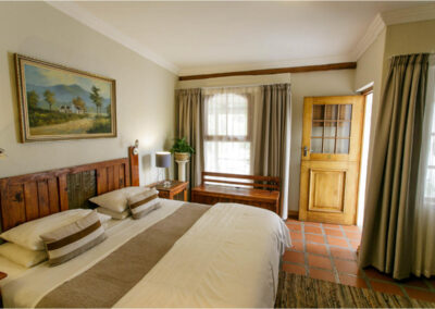 Oakdene Guest House Bedroom with chest in font of window