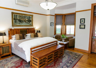 Oakdene Guest House bedroom with chair in corner