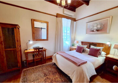Oakdene Guest House bedroom with desk and chair